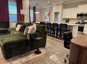 Experience the seamless flow of this expansive open-concept living space, offering effortless access to the living room, dining area, and kitchen. Professional photos coming soon.