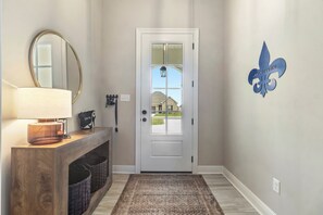Experience the best Airbnb in Lake Charles with a welcoming entrance that sets the tone for your stay. This pet-friendly home features modern décor, a stylish console, and convenient touches like key hooks and storage, making it the perfect retreat for comfort and relaxation.