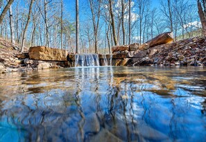 A cascading waterfall adds an extra touch of serenity, bringing the calming sound of running water to your outdoor experience.