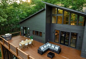 Lounge in style in this spacious outdoor area with gorgeous wooded views.