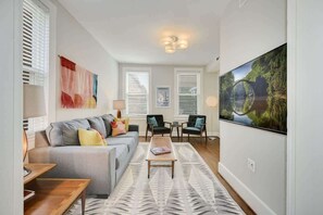 Living room with queen pullout sleeper sofa and 55" Smart LED TV