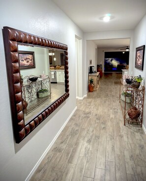 As you step into the hallway of your beautiful vacation rental, you're greeted by warm lighting, tasteful decor, and a sense of comfort that instantly makes you feel at home.