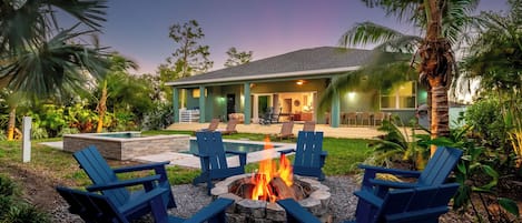 Enjoy a warm fire pit surrounded by lush greenery, ideal for your getaway!