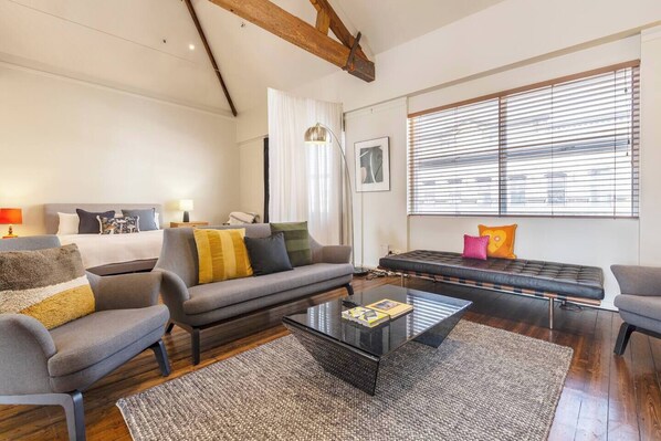 Settle in with a movie in the living area, where a sofa, armchairs and TV provide a welcoming space to return to after a day of work or sightseeing.