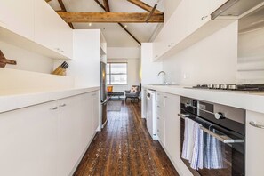 The modern, streamlined kitchen is equipped with everything you need to cook meals and a dishwasher for easy clean-up.