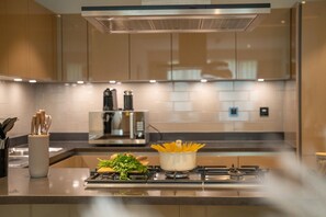 Convenient kitchen with stove, knife set, and coffee machine