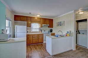 Discover culinary delights in the kitchen of our beachside retreat. A well-equipped space where seaside charm meets modern convenience, creating the perfect atmosphere for coastal cooking.