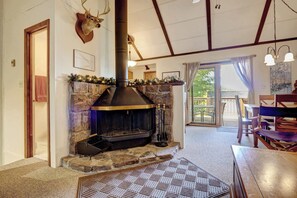 Unwind by the wood-burning fireplace, where flickering flames set the perfect mood for cozy memories in your mountain retreat