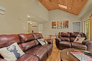 Discover comfort in our living room – sink into plush couches, feel the fireplace's warmth, enjoy smart TV entertainment, and step onto your private deck. Your ideal escape awaits.