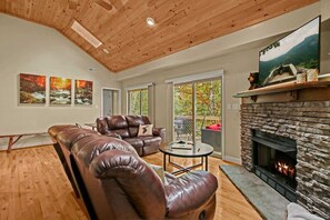 Indulge in comfort as you enter our chic living room – sink into plush couches, bask in the fireplace glow, enjoy smart TV entertainment, and step out to the stylish back deck!