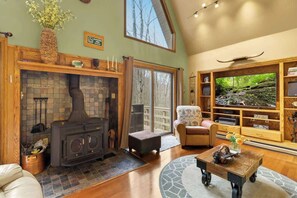 Lounge in luxury: Embrace comfort in our living room, where plush sofas, natural light, and a crackling fireplace set the stage for relaxation.
