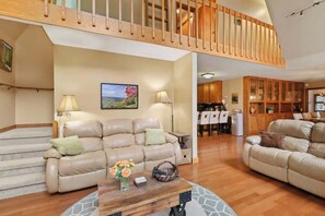 Our inviting living room invites you to sink into plush sofas, bathe in natural light, and unwind by the indoor wood-burning fireplace.