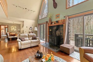 Living Room: Settle into our plush sofas, soak up natural light through open windows, and relax by the indoor fireplace.