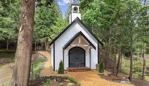 Tucked away beyond a custom wood bridge, the chapel adds a touch of romance and charm to the property.