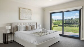 Wake up to stunning vineyard views in this master bedroom