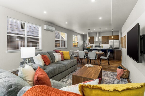 Beautiful open-concept layout, featuring a cozy living room, fully equipped kitchen, and dining area.