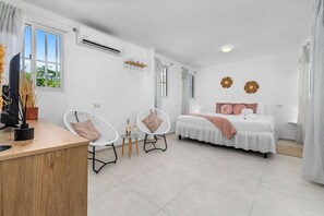 Unwind in this cozy bedroom designed for relaxation and entertainment. Featuring a plush bed with soft linens and pillows, it offers a serene space to rest after a long day.