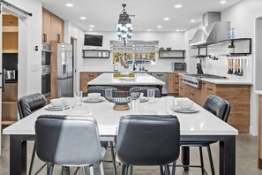 This gourmet kitchen has dining for 12 +, 6 at this pull out table, 6 at the island & 4 additional folding chairs available to sneak in a few more