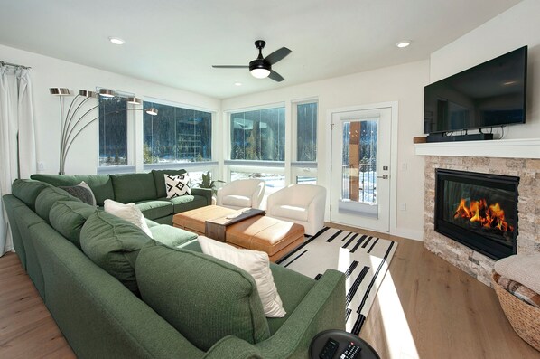 The main living area is flooded with natural light thanks to large windows and features access to two separate balconies.