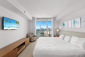 Experience luxury in our master bedroom with a king-sized bed and a connecting balcony offering stunning waterfront views.
