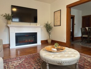 Main floor living room with electric fireplace.