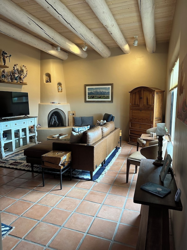 Living room has comfy seating and a gas kiva fireplace for chilly fall & winter!