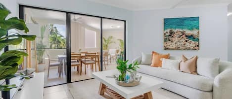The open-plan lounge room offers direct views and access to the outdoor dining area, making it an ideal gathering place for families.