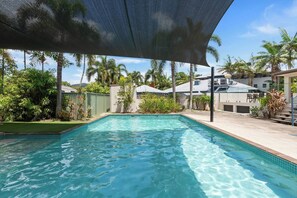 Take a refreshing dip in the shared pool, surrounded by tropical landscaping and relaxation areas.
