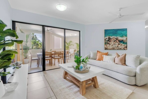 The open-plan lounge room offers direct views and access to the outdoor dining area, making it an ideal gathering place for families.
