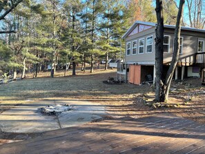 Flat spacious backyard overlooking the lake with a  fire pit for family fun.