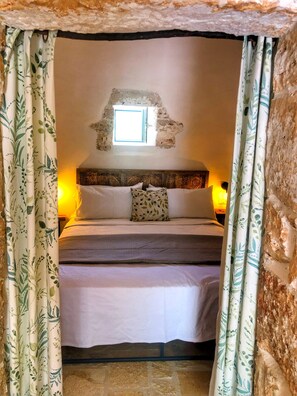 Trullo Suite Rosamarino view of bed from lounging area