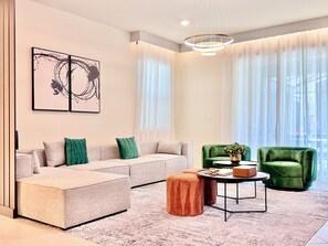 Emblematic living room with comfortable sofa and armchairs in green.