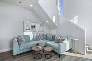 Bright living area with plush seating and natural light.