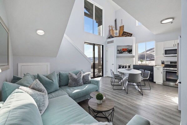 Spacious living area with vaulted ceilings and cozy sectional.