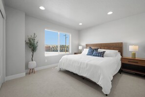 Bedroom features a king bed with full en suite bathroom and views of mountains