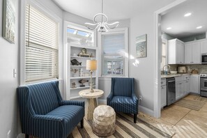 A cozy and functional space in the hallway featuring comfortable seating, perfect for a quick break or intimate conversations.