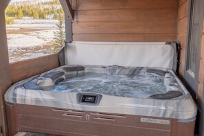 The luxurious hot tub surrounded by serene mountain beauty.