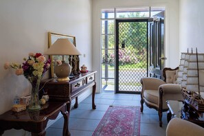 Welcoming entrance way filled with antique-style furniture