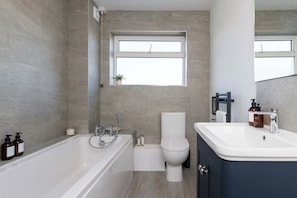 Modern bathroom with a sleek design and full amenities.