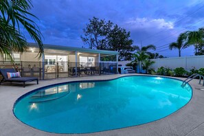 Our backyard at night is a serene escape, with soft lighting and cozy spots for evening relaxation.
