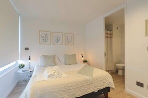 Relax in this serene bedroom with an ensuite bathroom, perfect for a peaceful getaway.