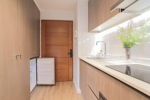 Charming compact kitchen with modern amenities and a cozy vibe, perfect for preparing delightful meals during your stay.
