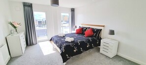 Master bedroom with king size bed, en-suite and access to balcony