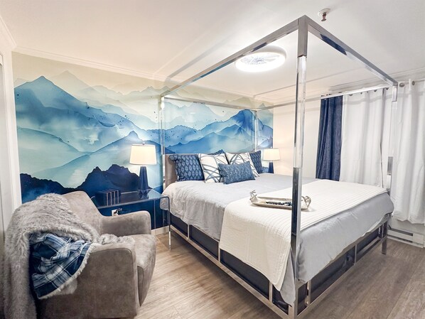 The first KING bedroom is themed for your mountain getaway, and features a Casper mattress, designer bed, writing desk, comfy swivel chair, and 55-inch smart TV.