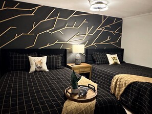 One bedroom has two queen beds with a 55-inch smart TV.