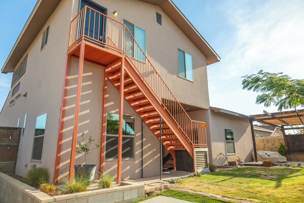 Upstairs guest house. Entry is up the orange stairs and through the blue door