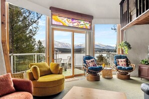 Glorious panoramic mountain & lake views from the cozy 70s themed living area.