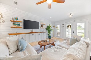 This bright and comfortable living room is perfect for unwinding after a day at the beach!