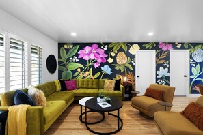 Vibrant Living room featuring a custom wall mural by a local artist