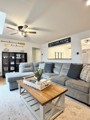 Inviting living room seamlessly flows into kitchen with bartop for conversation